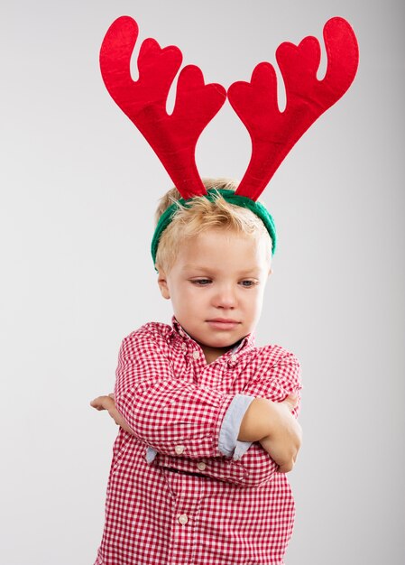 Child angry with reindeer antlers