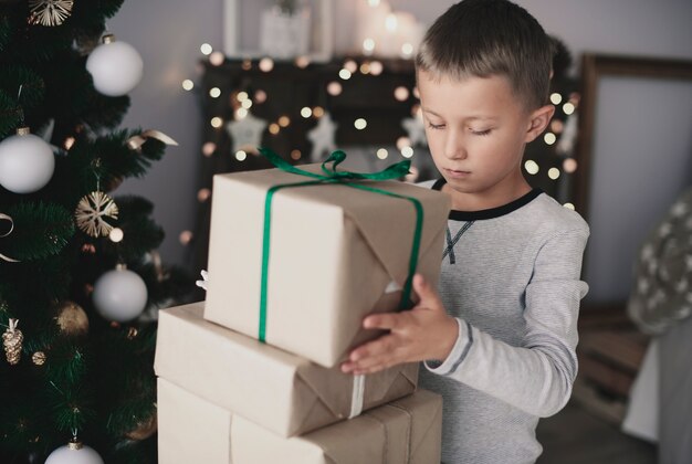 Child arranging gift on the top of the other