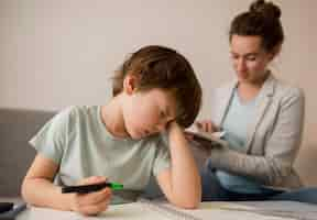 Free photo child being tired while tutored at home