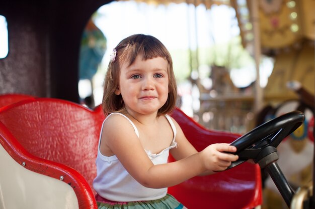 child in carousel car