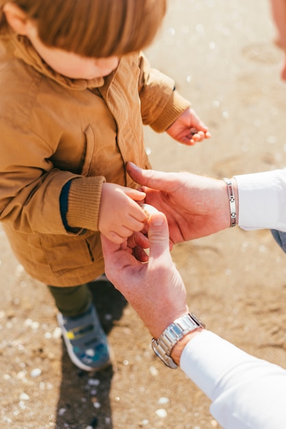 Free photo child in coat playing with parent