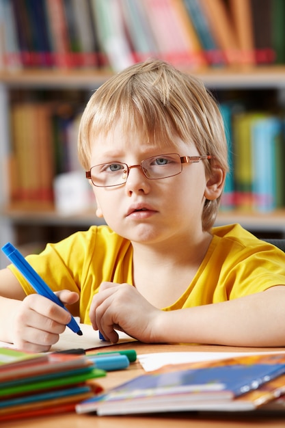 Child drawing in the library