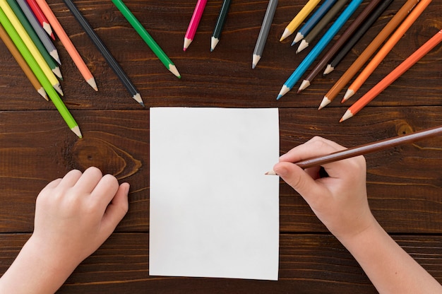 Child drawing with colorful pencils