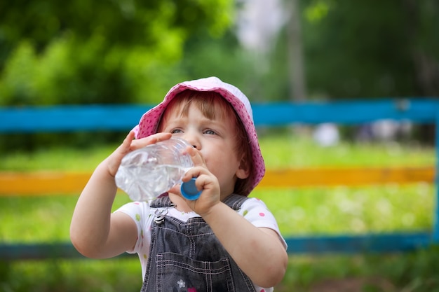 child drinks from  bottle