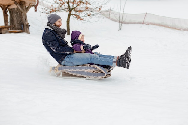 Child enjoying winter activities with their family