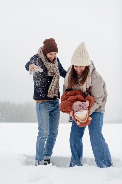 Child enjoying winter activities with their family