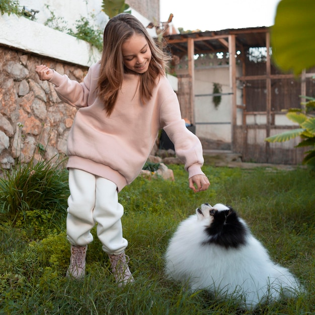 Free photo child giving treat to her dog