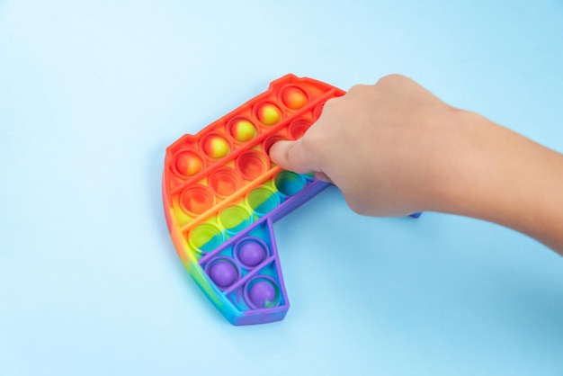 Child hand playing with pop it toy