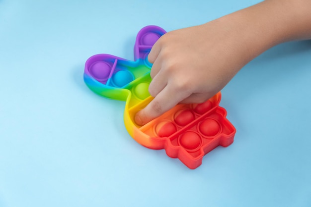 Child hand playing with pop it toy