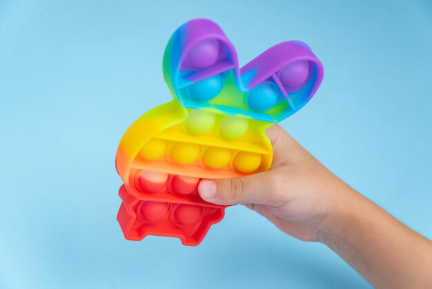 Child hand playing with pop it toy