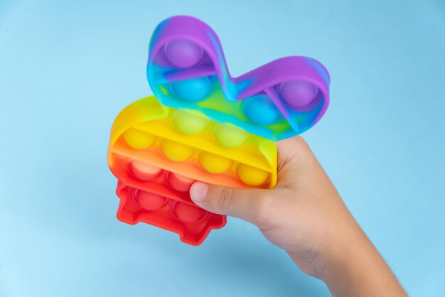 Child hand playing with pop it toy