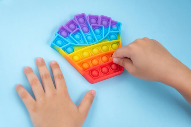 Child hand playing with pop it toy