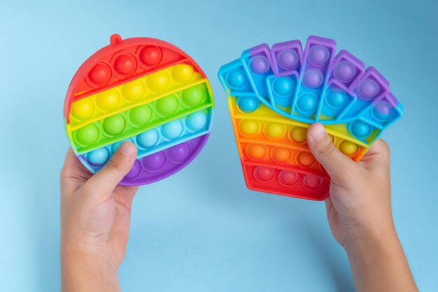 Child hand playing with pop it toy