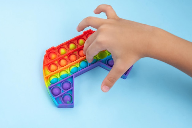 Child hand playing with pop it toy