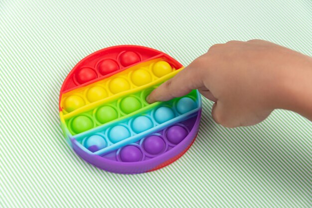 Child hand playing with pop it toy