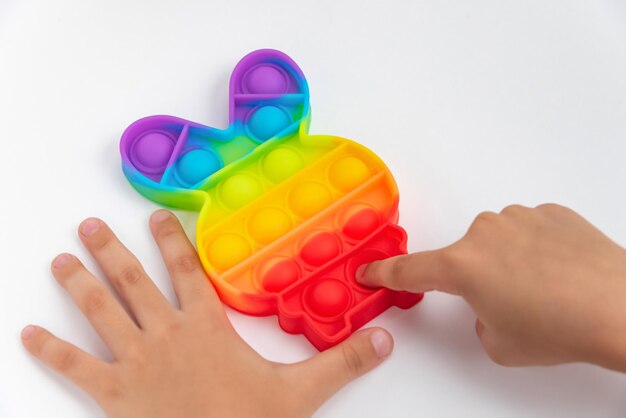 Child hand playing with pop it toy