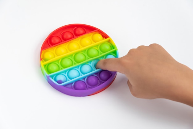 Child hand playing with pop it toy