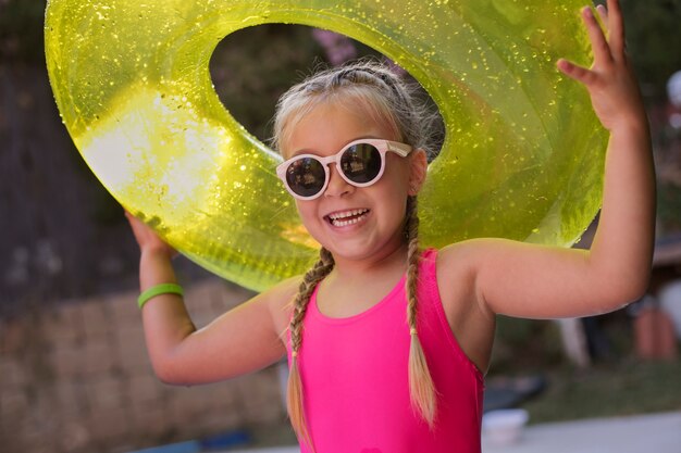 Child having fun with floater by the pool