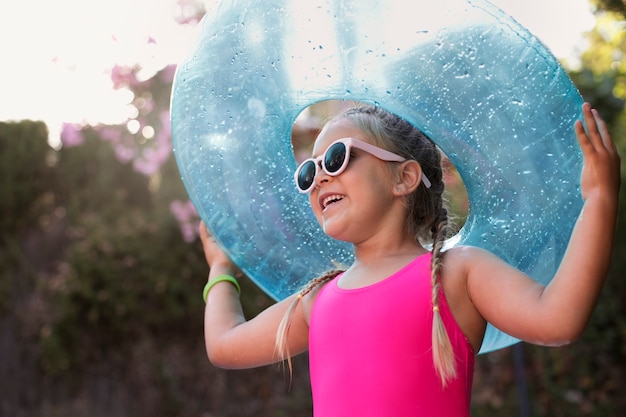 Free photo child having fun with floater by the pool