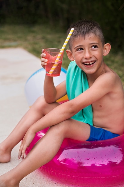 Child having fun with floater by the pool