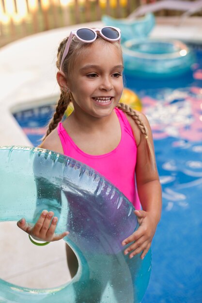 Child having fun with floater by the pool