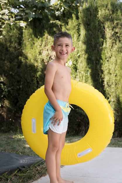 Child having fun with floater by the pool