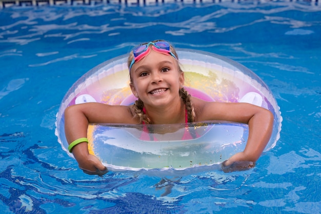 Free photo child having fun with floater at the pool