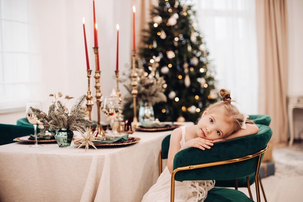 Child having a seat during a boring meal at the celebration table