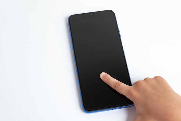 Free photo child holding cellphone over white background