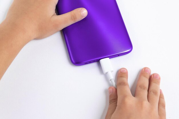 Child holding cellphone over white background