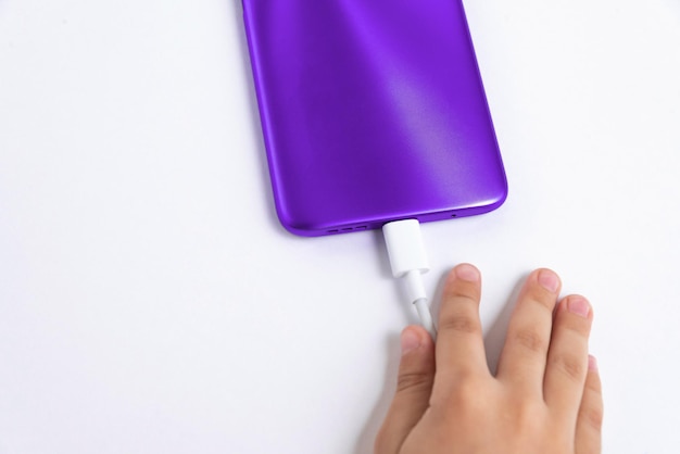 Child holding cellphone over white background