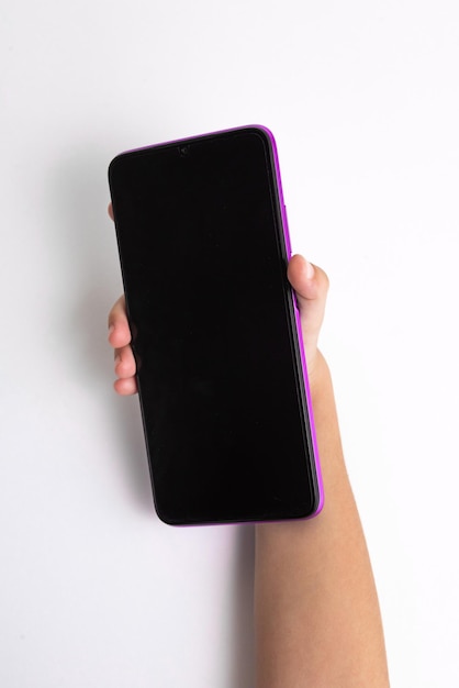 Free photo child holding cellphone over white background