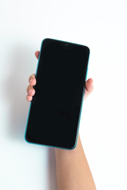 Free photo child holding cellphone over white background