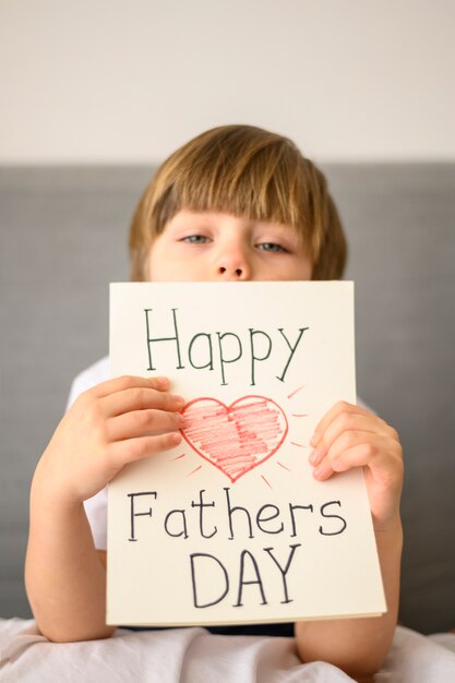 Child holding father's day greeting card