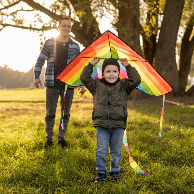 Child holding a kite above his head