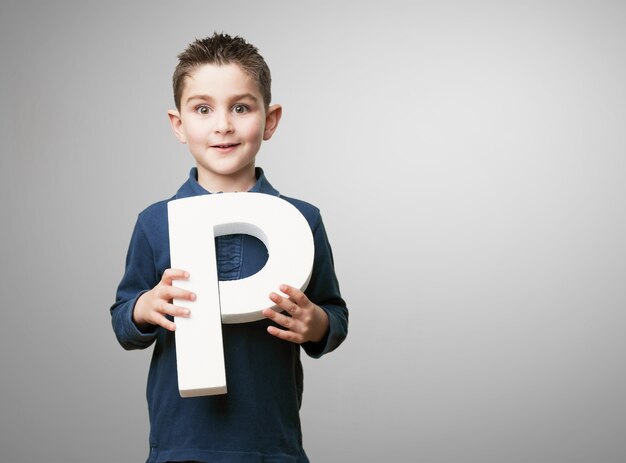 Child holding the letter "p"