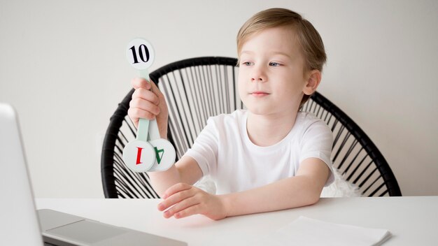 Child holding numbers for mathematics online course