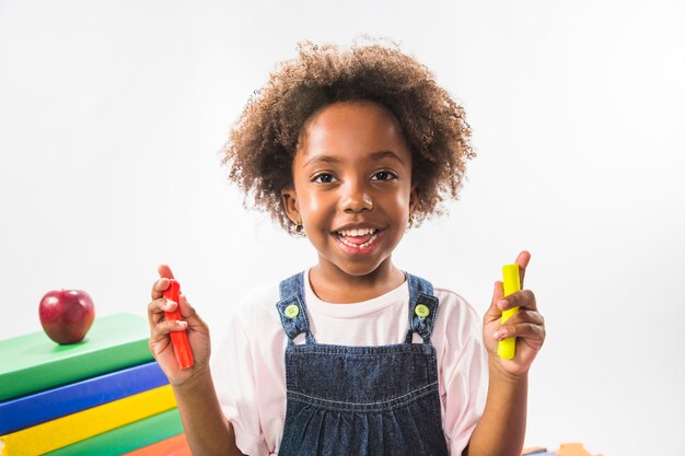 Child holding plasticine in studio 