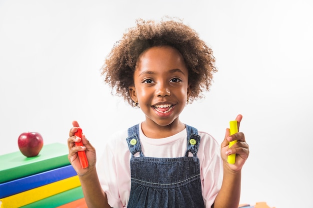 Child holding plasticine in studio 