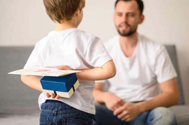 Child holding surprise for father