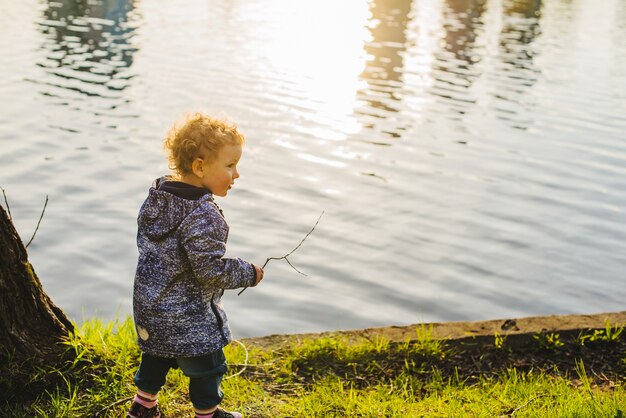 Child holding a twig