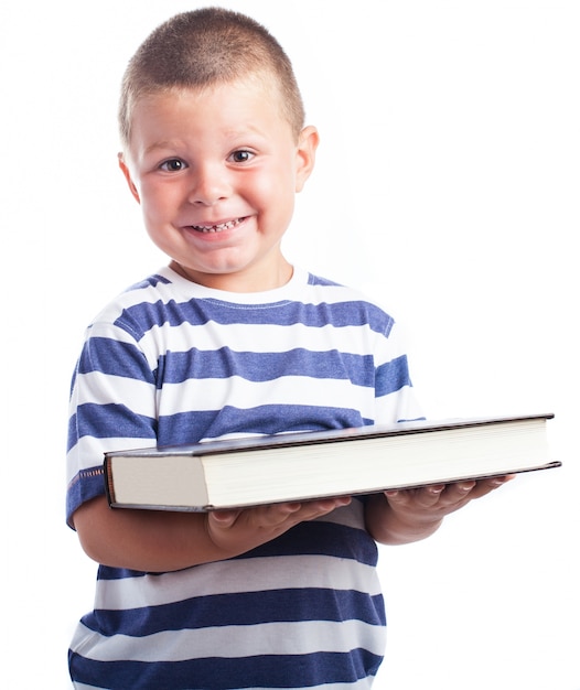 Free photo child holding a very large book