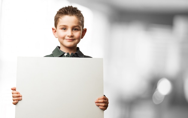 Free photo child holding a white poster