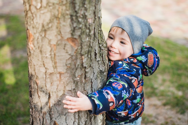 Child hugging tree