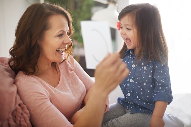 Child learning alphabet with her mother