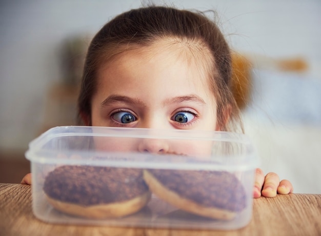 Child looking at delicious donuts