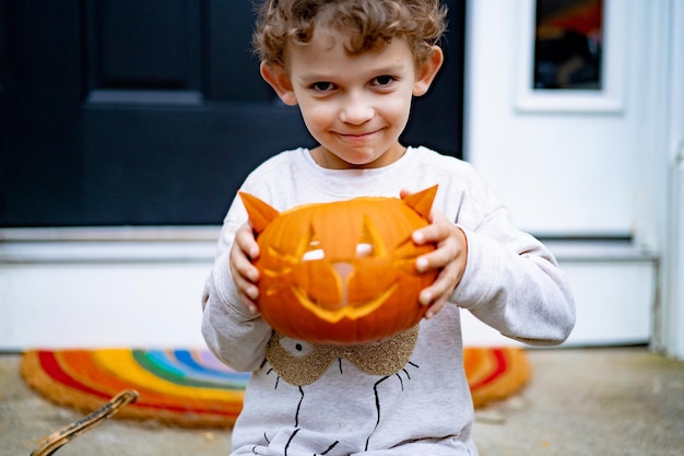 Free photo child makes pumpkin for halloween