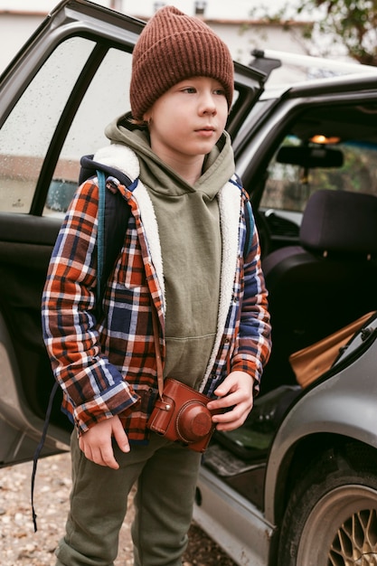 Free photo child outdoors with car on a road trip