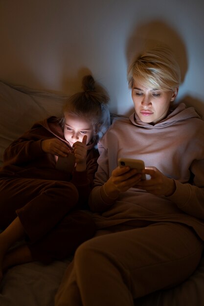 Child and parent suffering from social media addiction