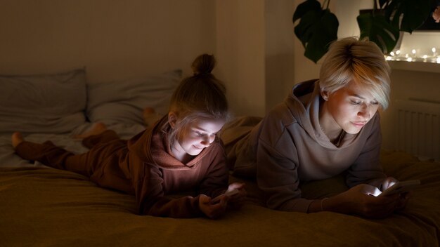 Child and parent suffering from social media addiction